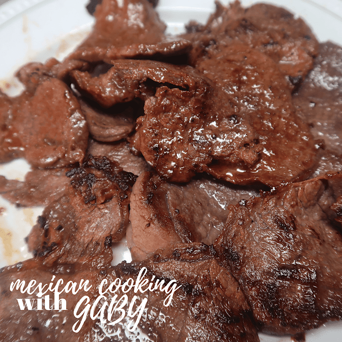 Close up of pieces of Mexican marinated steak on a plate.