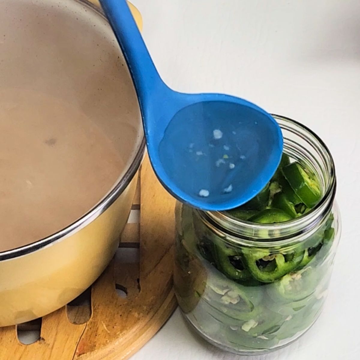 filling the jars with water for the pickled jalapenos recipe