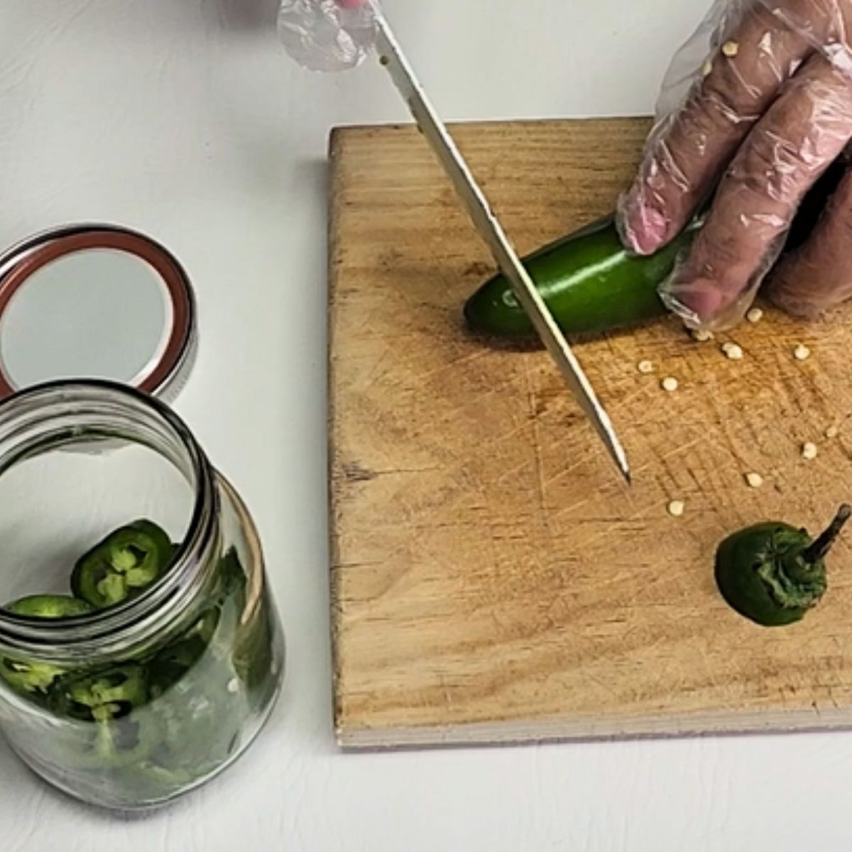slice all the peppers and ad it to the jar. pickled jalapeno peppers.